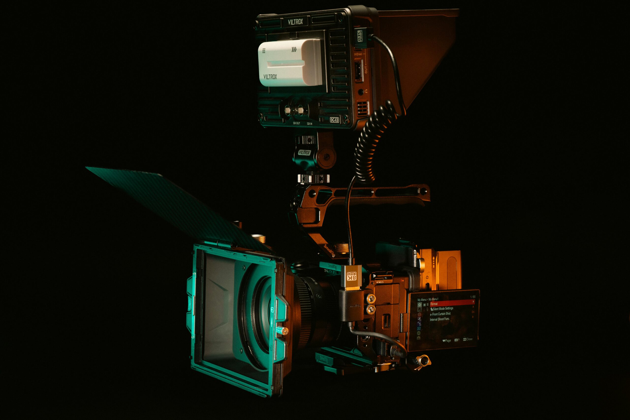 A detailed view of a cinema camera rig setup with Viltrox monitor and accessories.